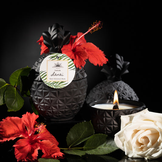 Candle in black pineapple jar scented with rose, hibiscus and musk.