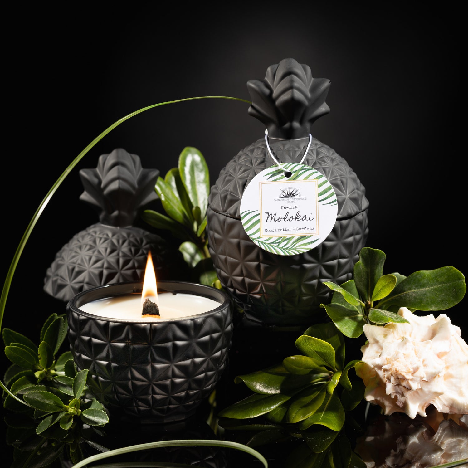Candle in black pineapple jar scented with cocoa butter and surf wax. 